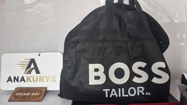 Boss Tailor garment bag holding the recovered suit at Ana Kurye’s office