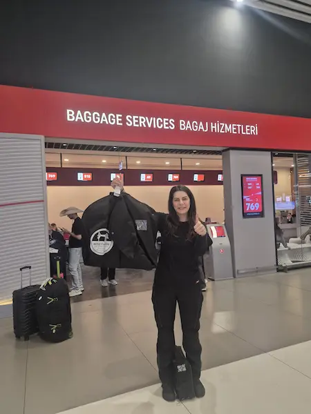 Ana Kurye representative holding Chris’s recovered suit bag at Istanbul Airport Baggage Services